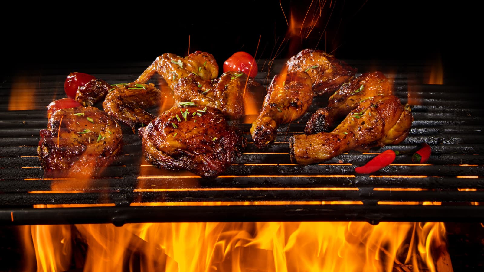 Chicken sizzling over the open tandoor flame